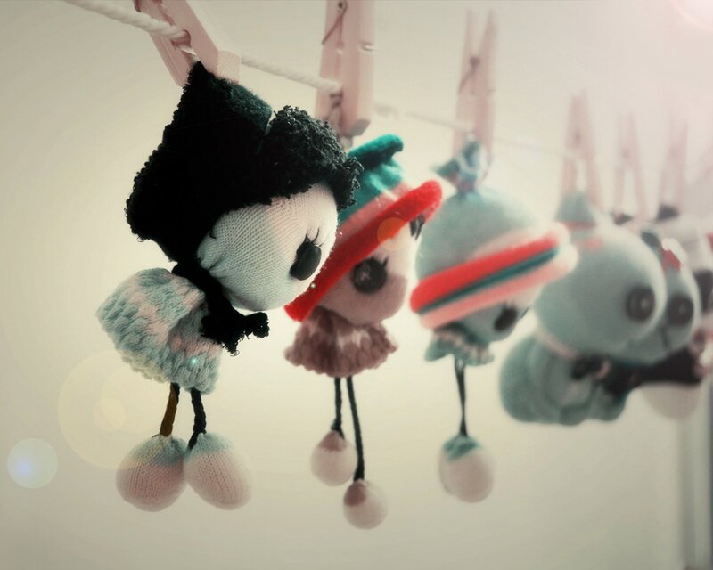 Stuffed dolls hanging on a line
