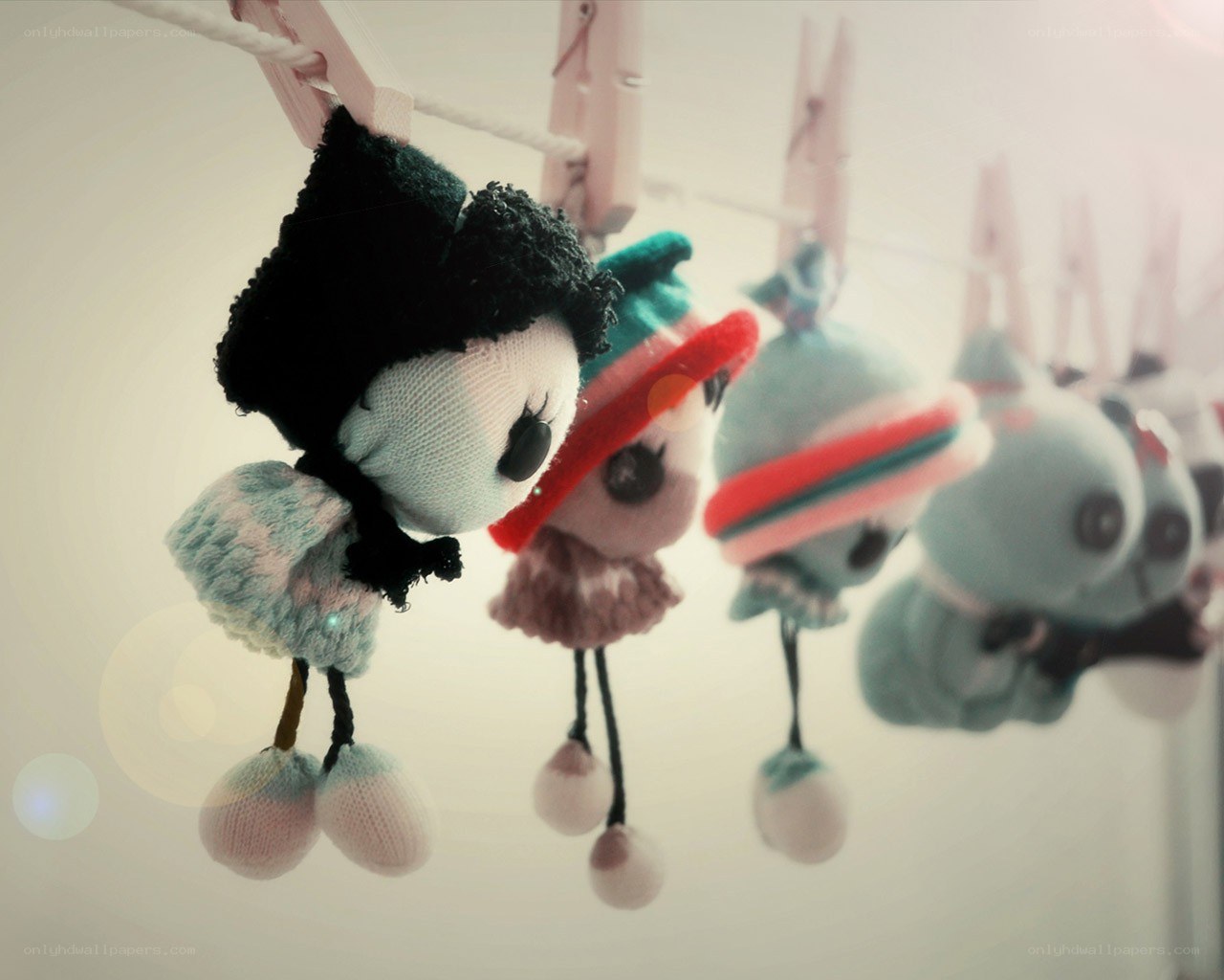 Stuffed dolls hanging on a line