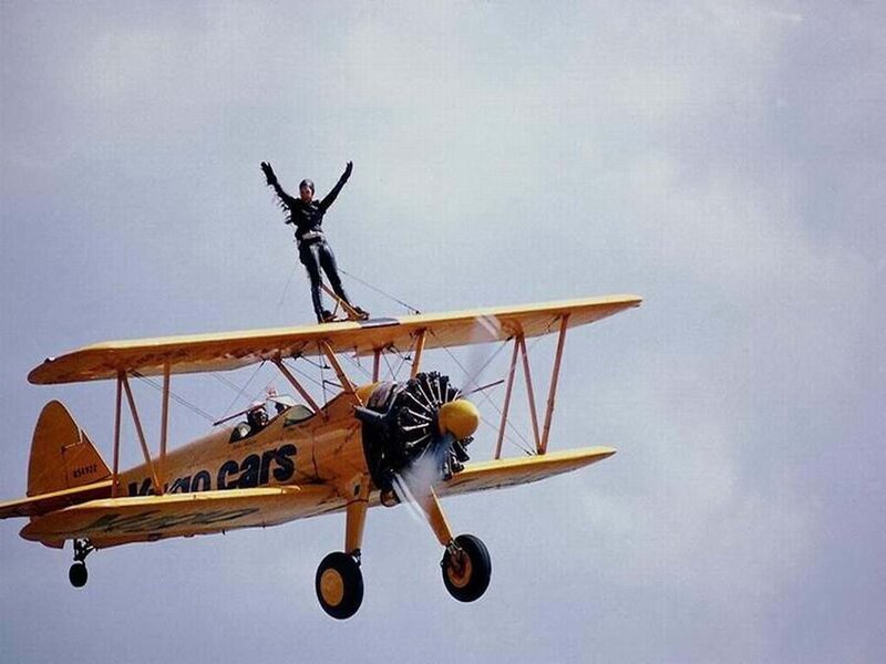 Stunt performer on biplane