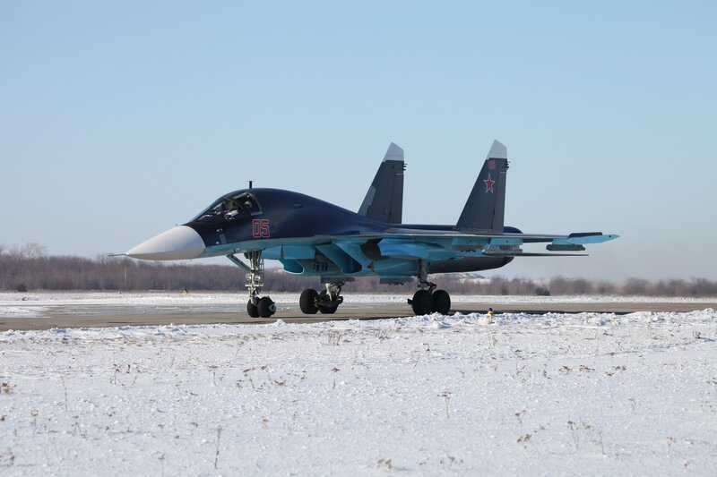 Su-34 fighter jet on snowy runway
