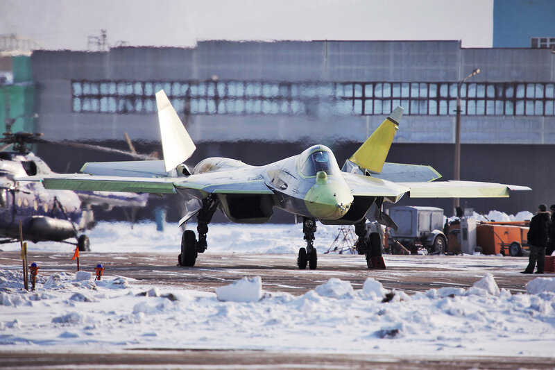 Su-57 fighter jet on snowy tarmac