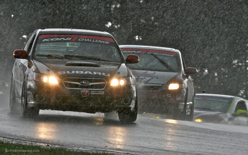 Subaru race cars in rain