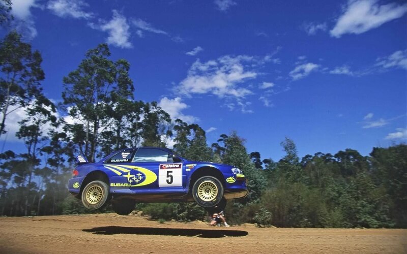 Subaru rally car in mid-air jump
