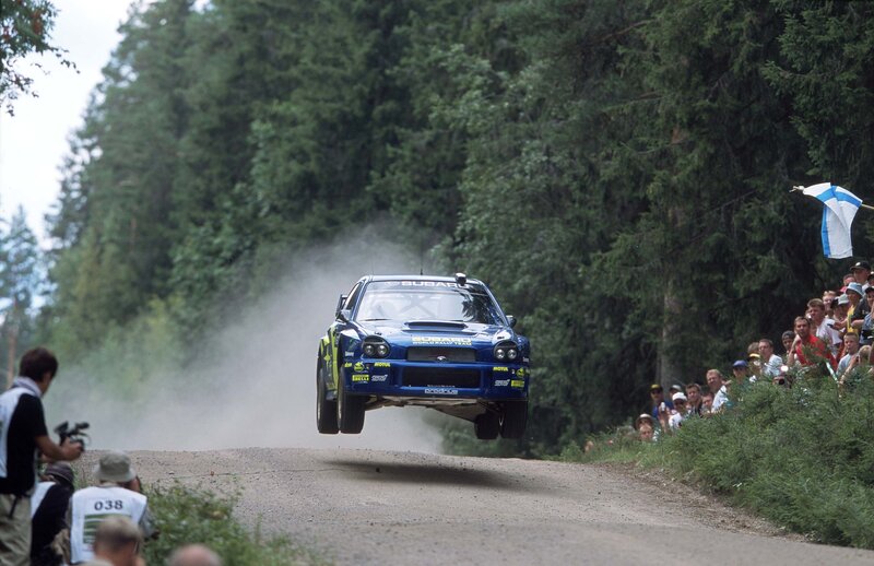 Subaru rally car in mid-air jump