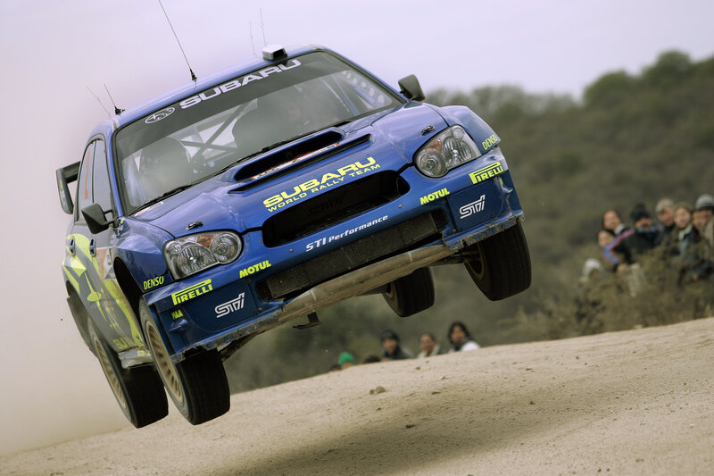 Subaru rally car in mid-air jump