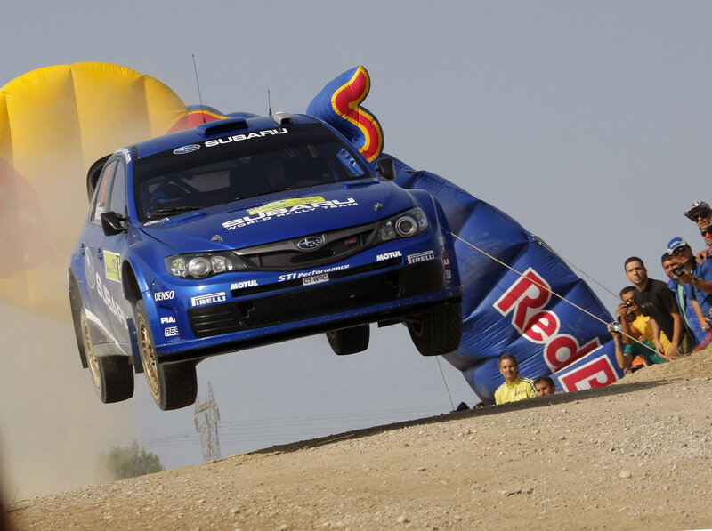 Subaru rally car in mid-air jump