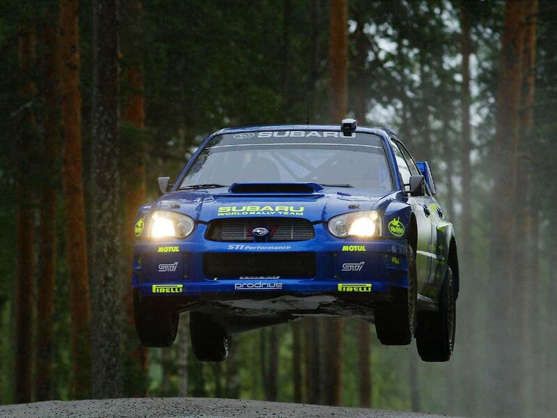 Subaru rally car in mid-air jump