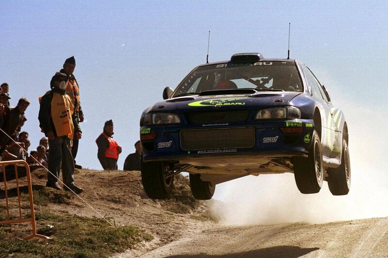 Subaru rally car in mid-air jump
