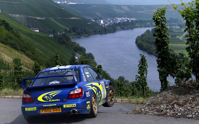 Subaru rally car on a scenic road
