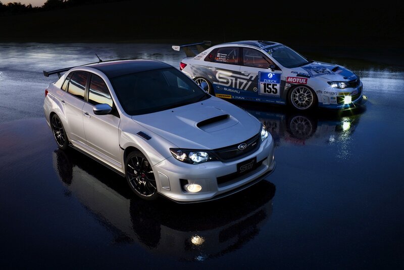 Subaru STI cars on wet track