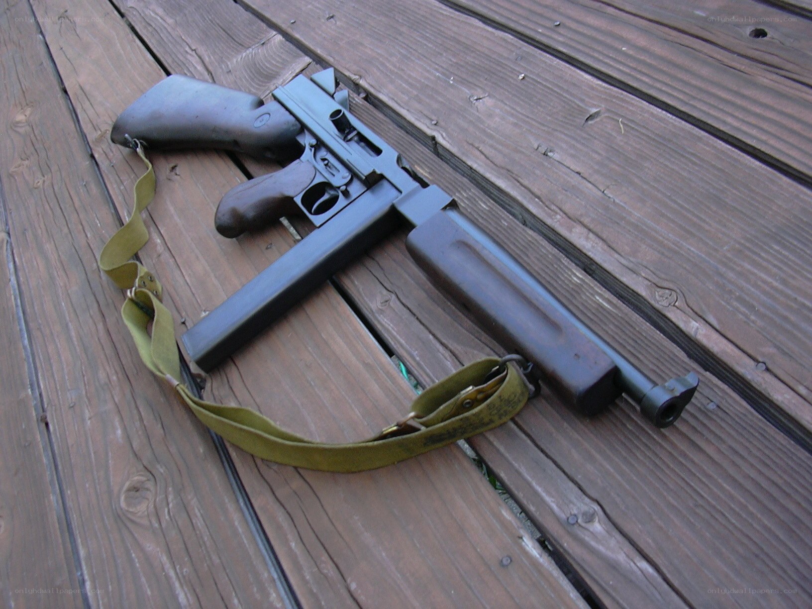 Submachine gun on wooden deck