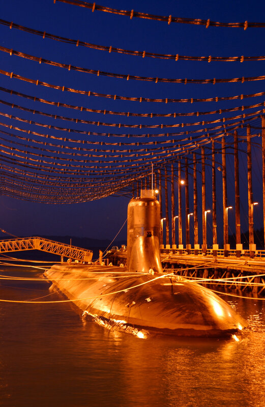 Submarine at dock at night