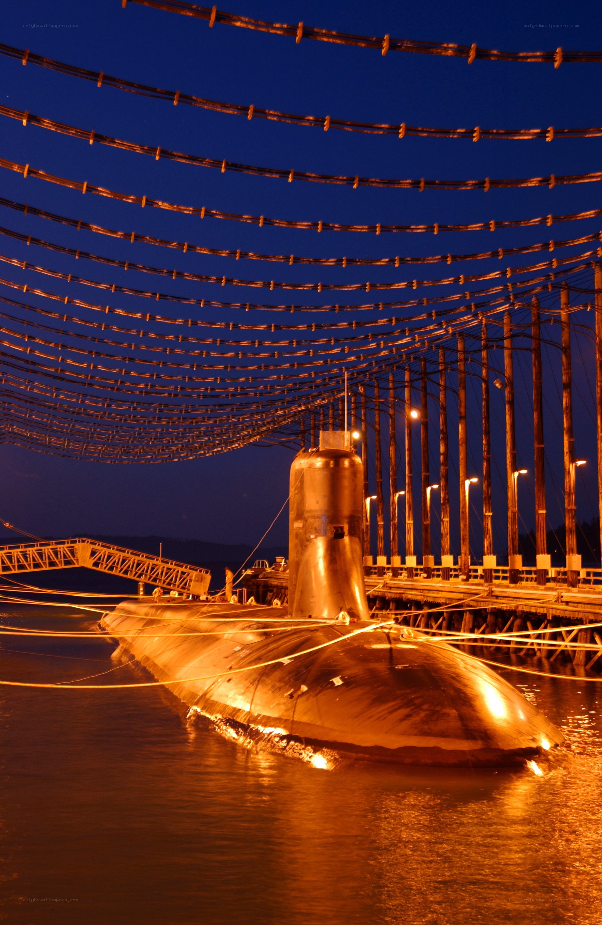 Submarine at dock at night