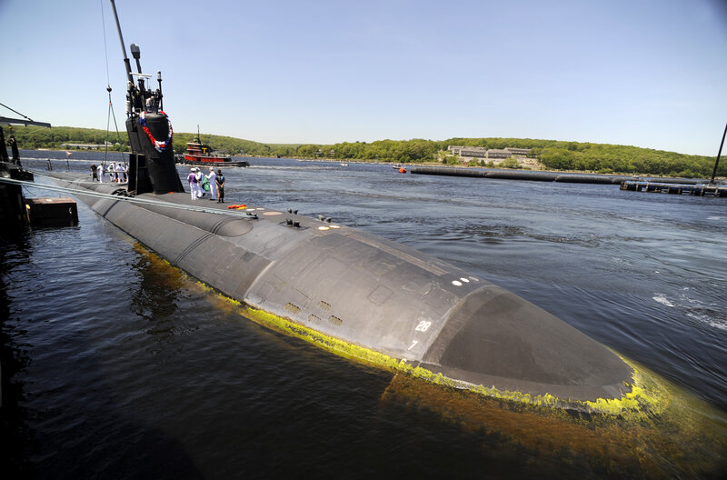 Submarine at dock with crew