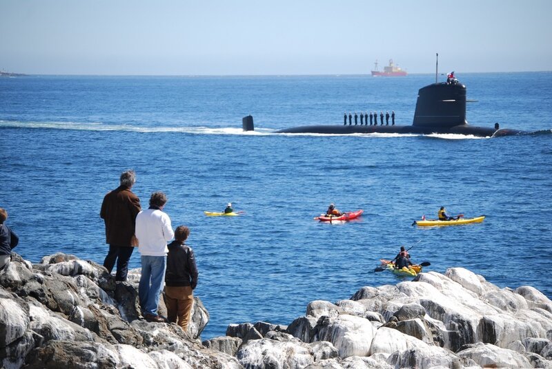 Submarine at sea with kayakers
