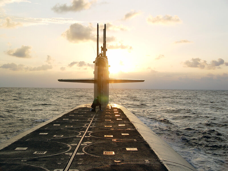 Submarine at sunset on open sea