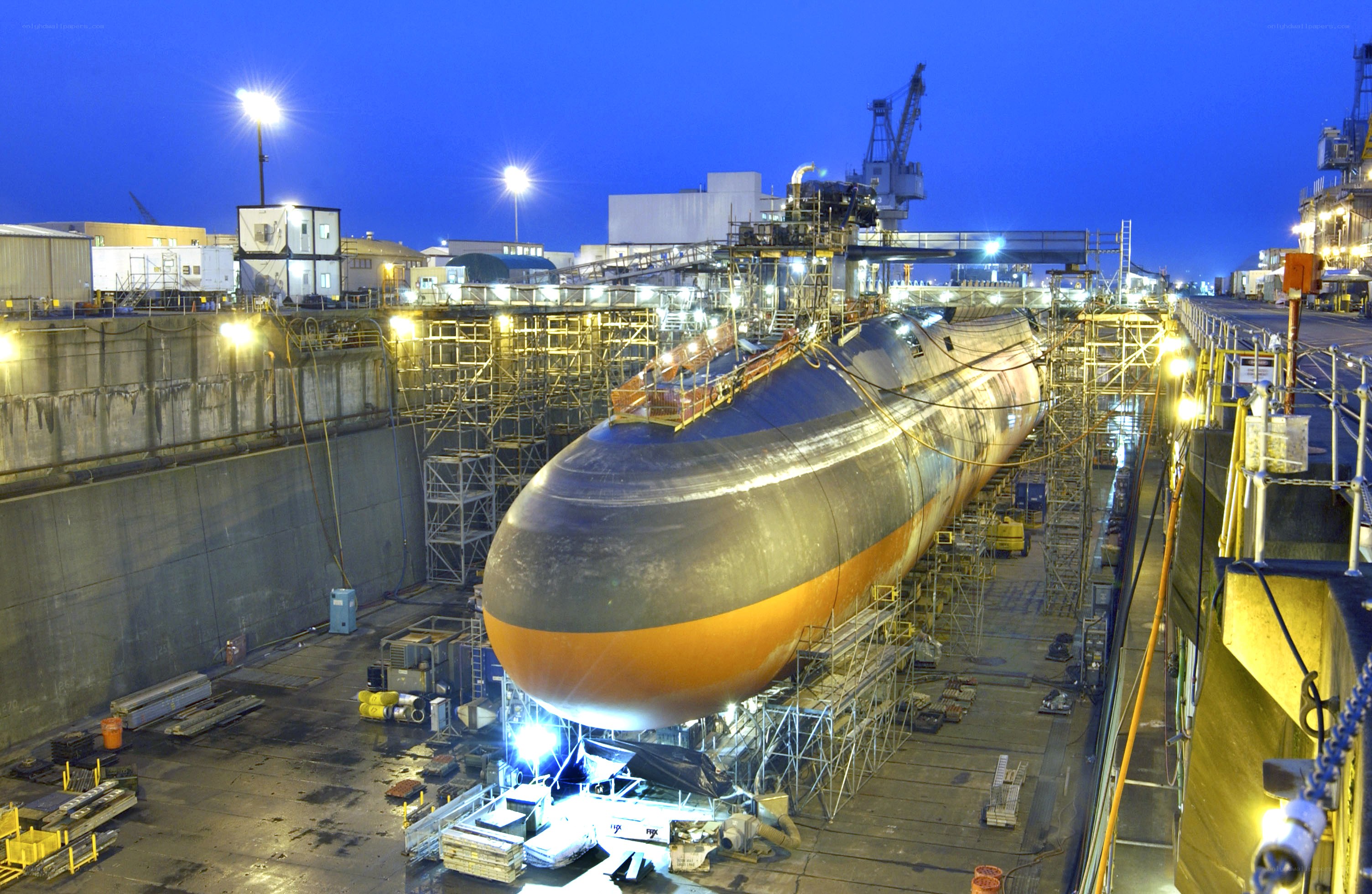 Submarine in dry dock at night