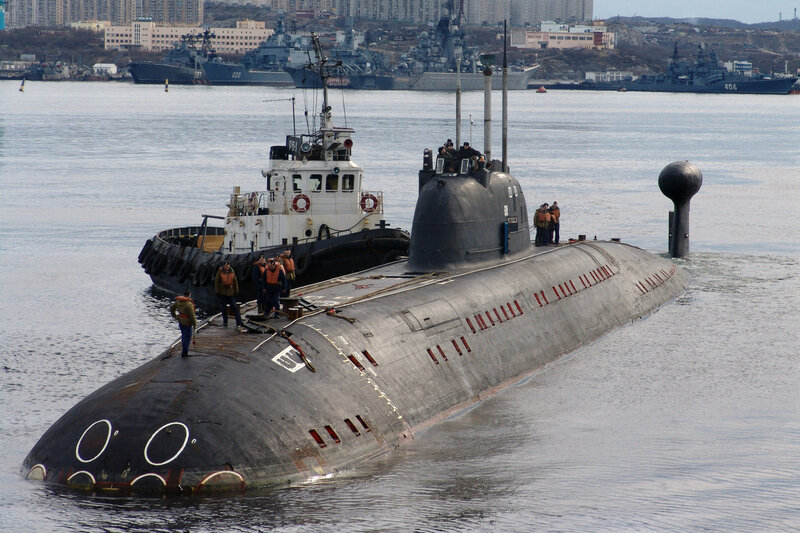Submarine in port with tugboat