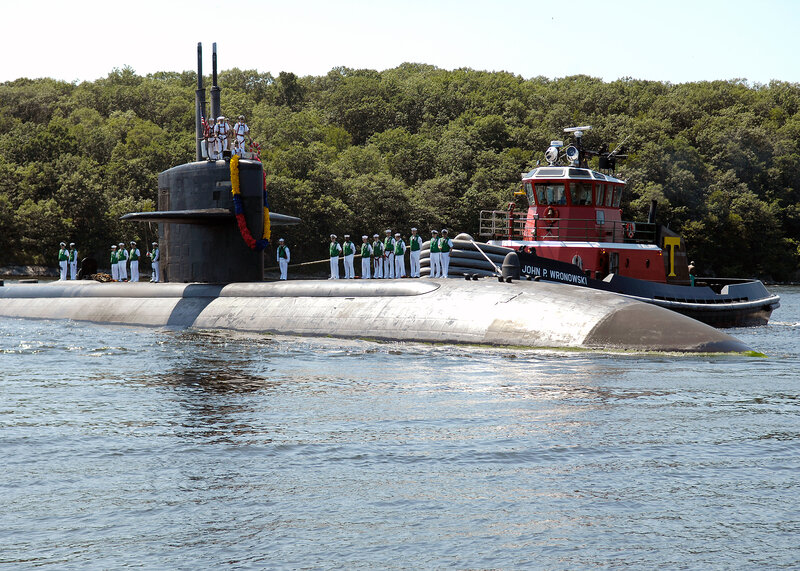 Submarine with crew and tugboat