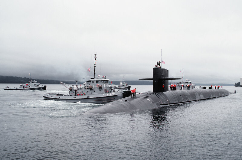 Submarine with tugboats