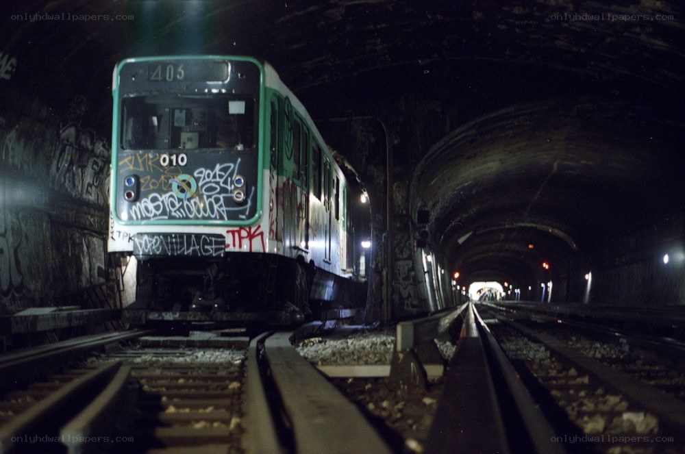Subway train in a graffiti-covered tunnel