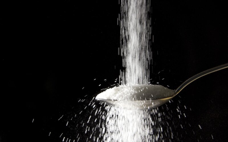 sugar falling on a spoon