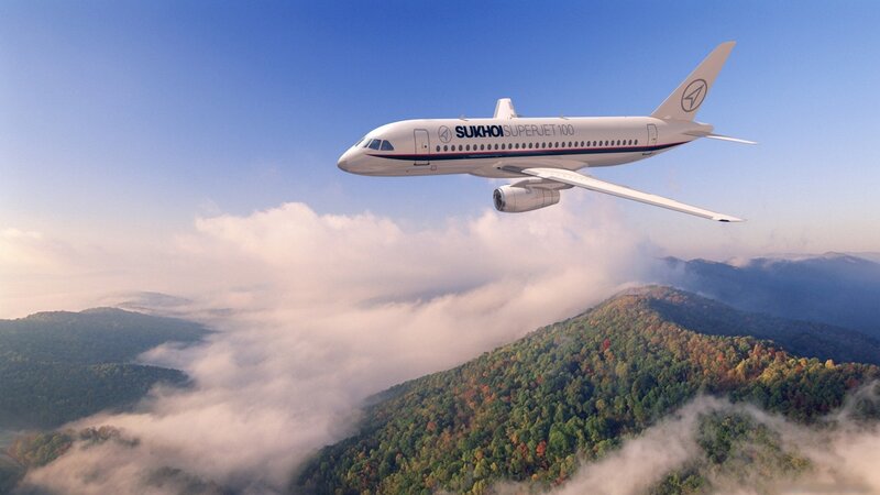 Sukhoi Superjet flying over mountains