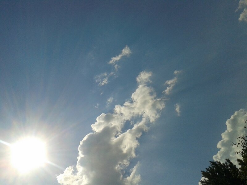 Sun and Clouds in Sky — Blue