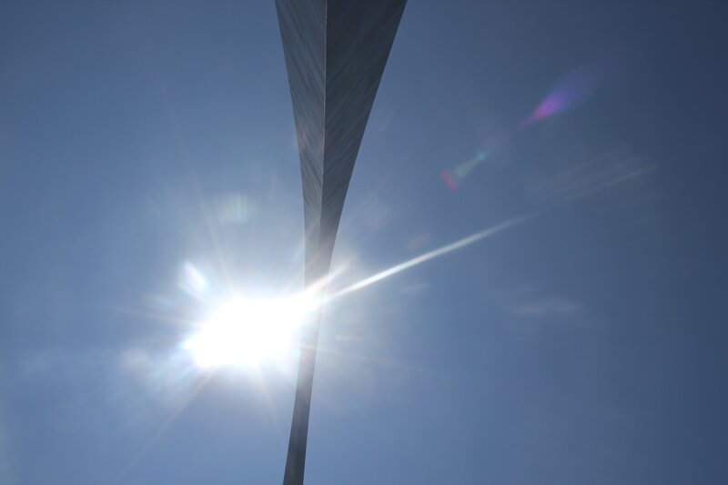 Sun behind a tall structure