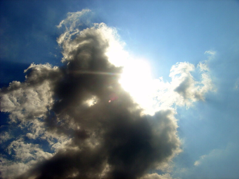 Sun behind dark clouds