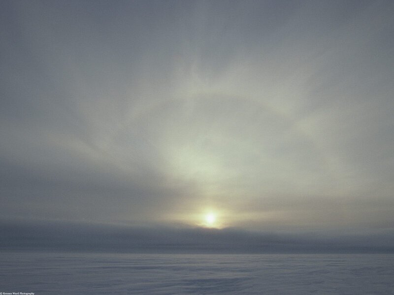 Sun halo over snowy landscape