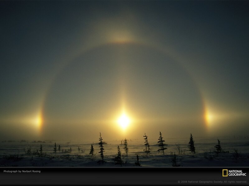 Sun halo over snowy landscape