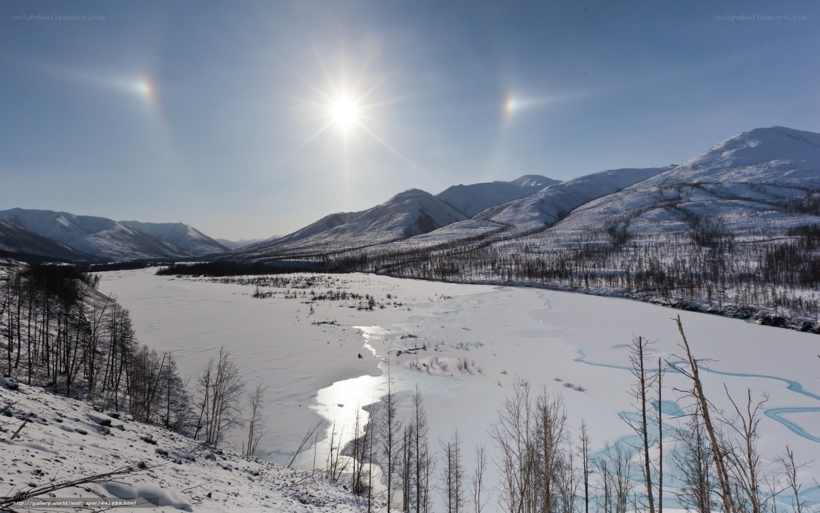 Sun halo over snowy mountains