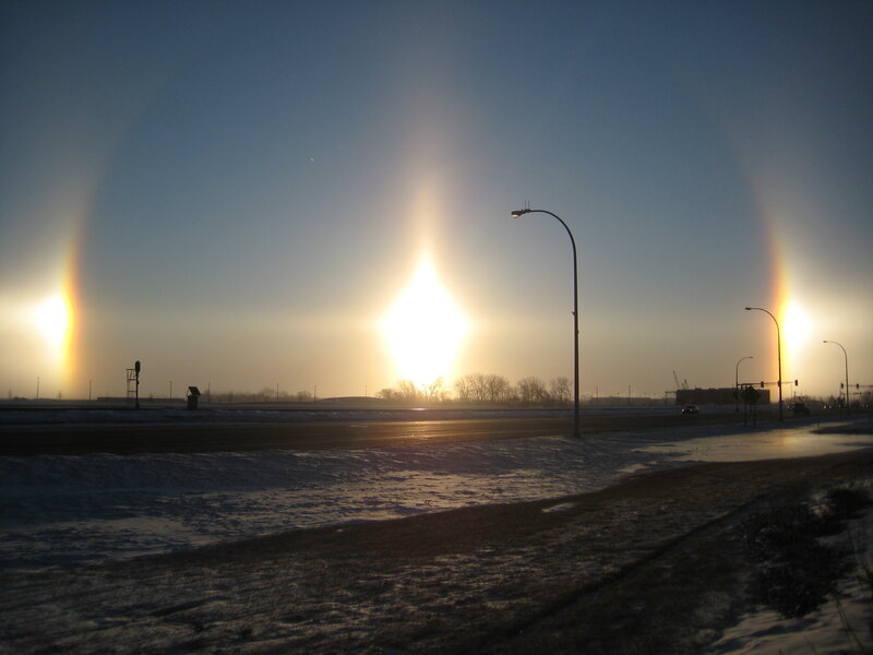 Sun halo over snowy road