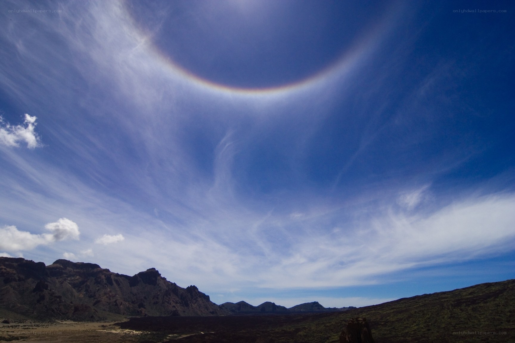 Sun halo over volcanic landscape