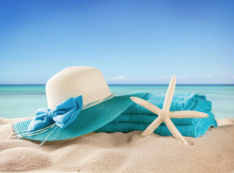Sun Hat and Towel on Beach