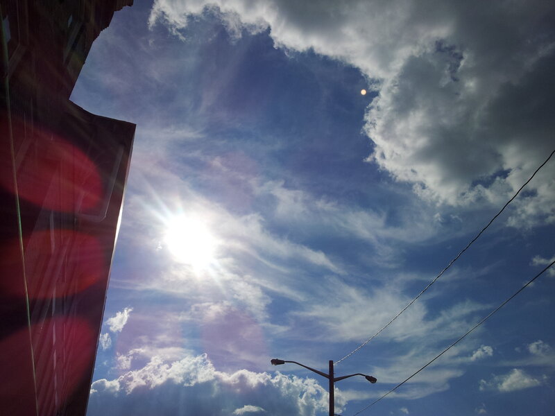 Sun in Cloudy Sky — Blue