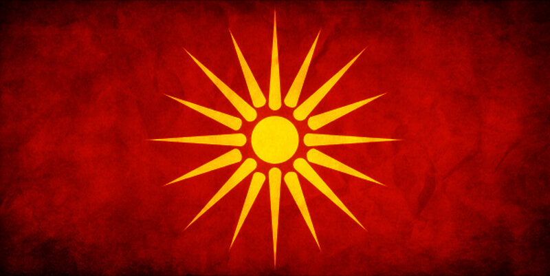 Sun of Vergina on red background