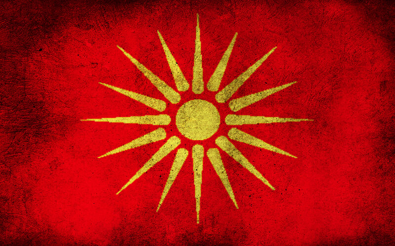 Sun of Vergina on red background