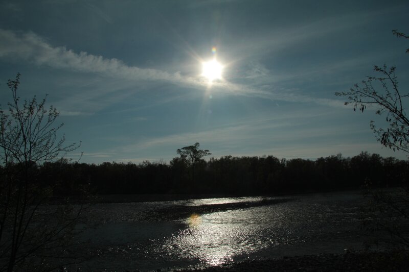 Sun over a river at dusk