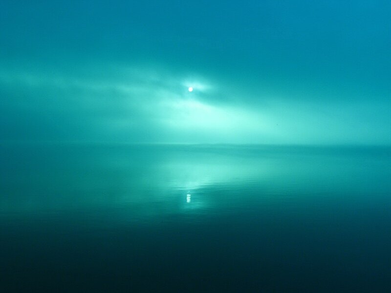 Sun over calm sea