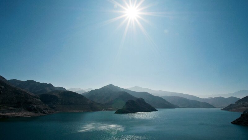 Sun over mountain lake