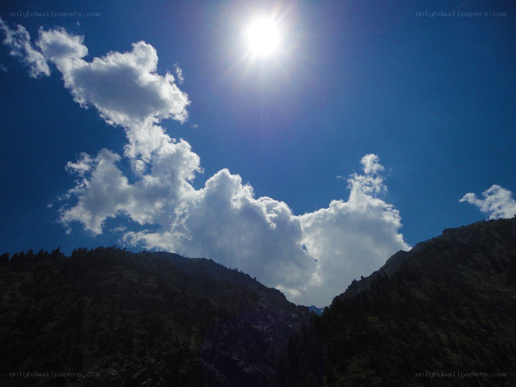 Sun over mountain peaks