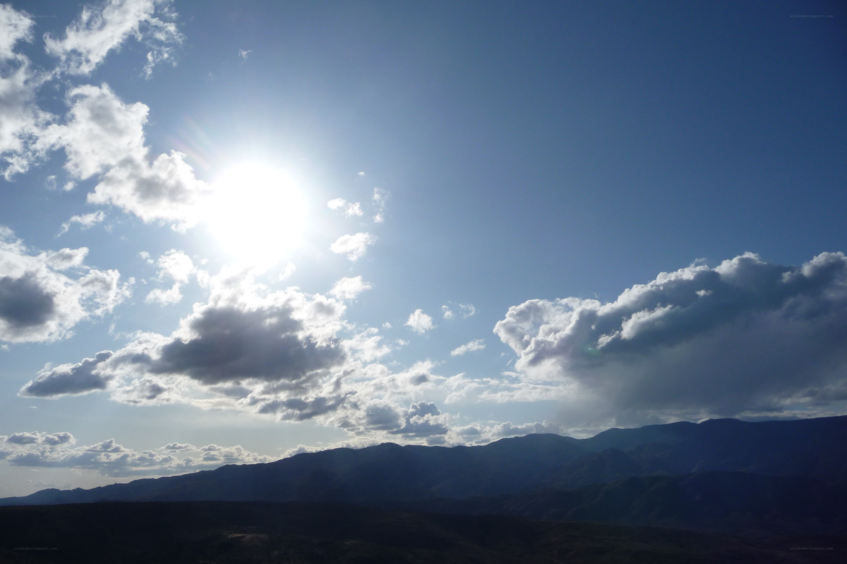 Sun over mountain range