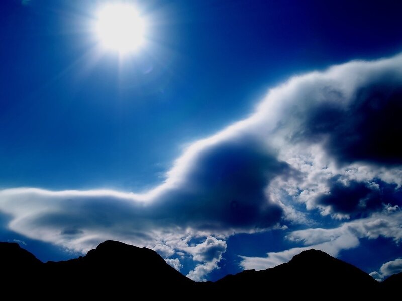 Sun over mountain silhouette