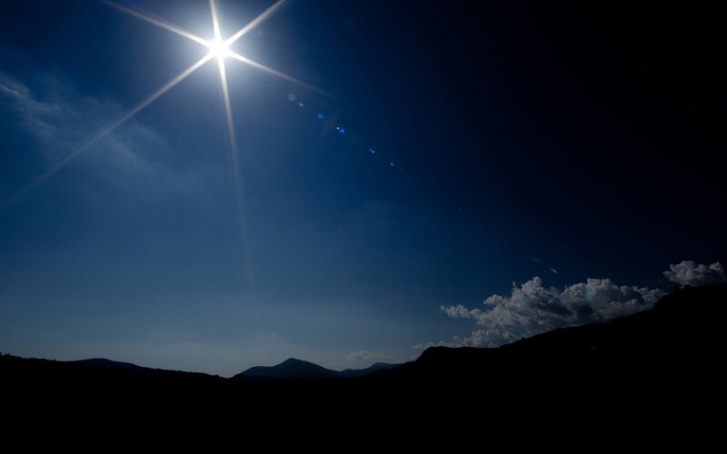Sun over mountain silhouettes