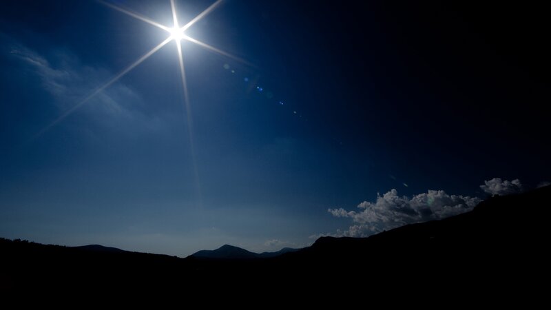 Sun over Mountain Silhouettes — Blue, Dramatic
