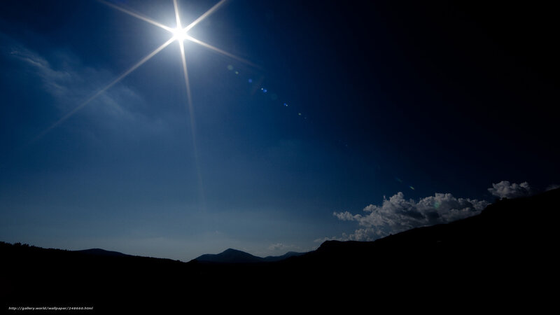 Sun over mountain silhouettes