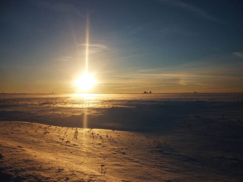 Sun over Snowy Field