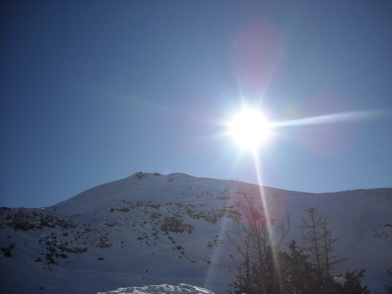 Sun over snowy mountain